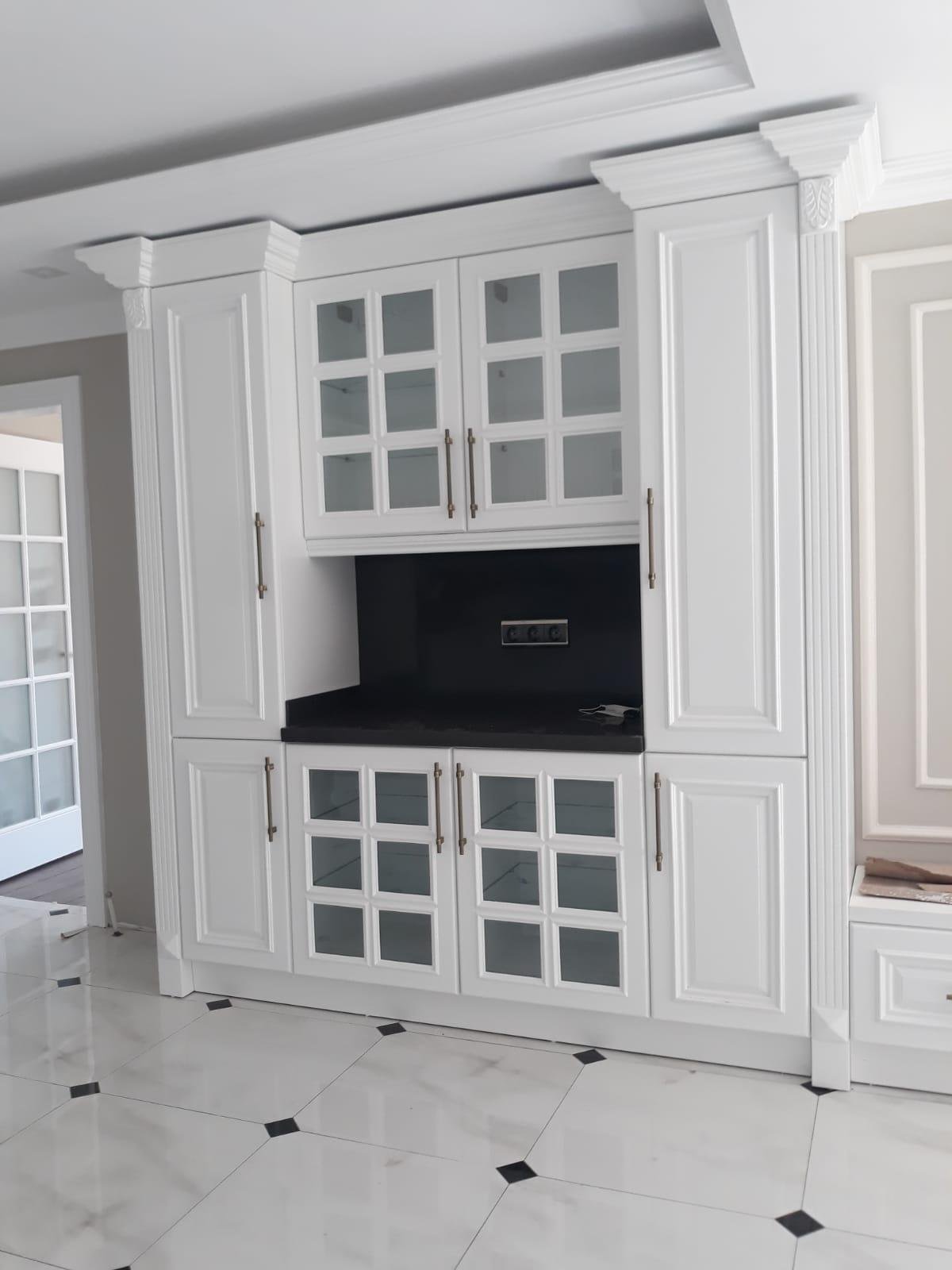 Blue paneled wall unit with sliding doors and integrated bookshelf